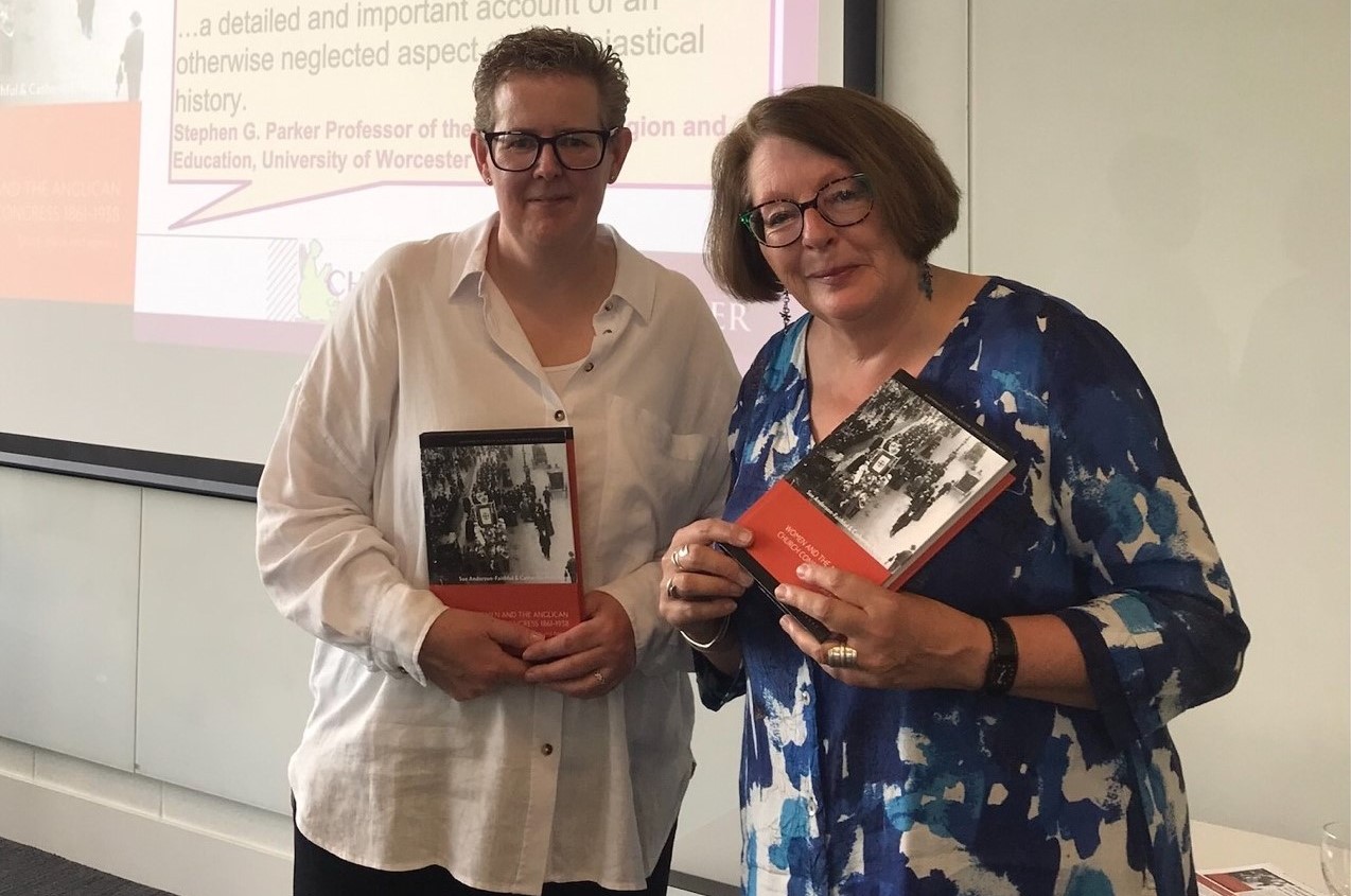 two women holding books