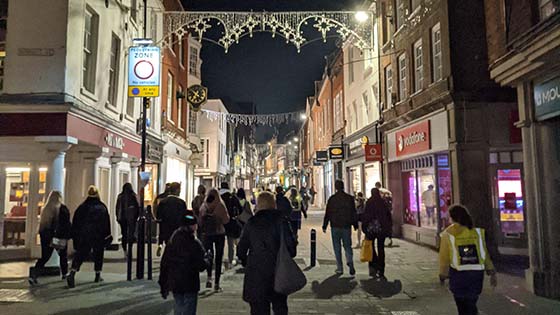 Walkers in the High Street with Christmas lights