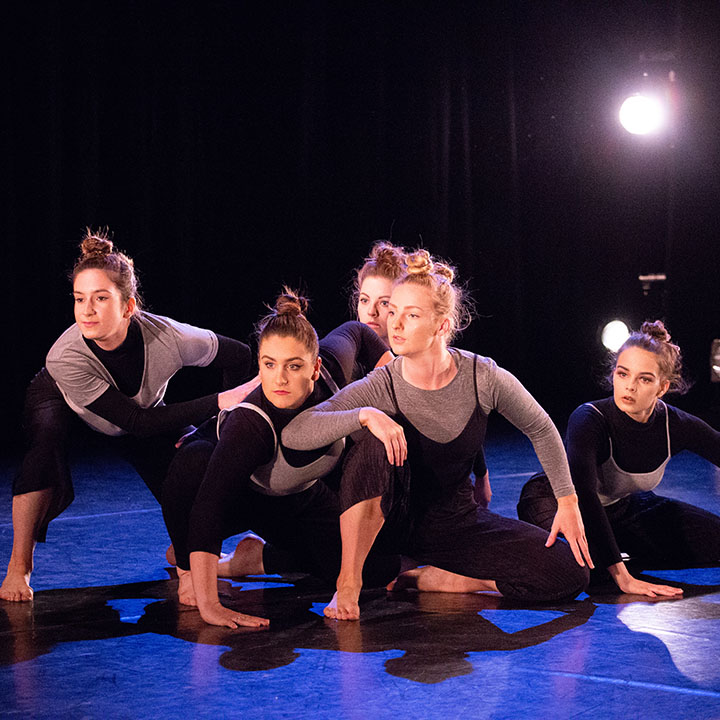 Five female contemporary dancers performing