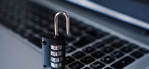 Security padlock placed on computer keyboard