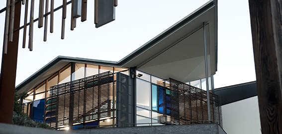 Exterior of modern building with ziggurat roof and coloured windows