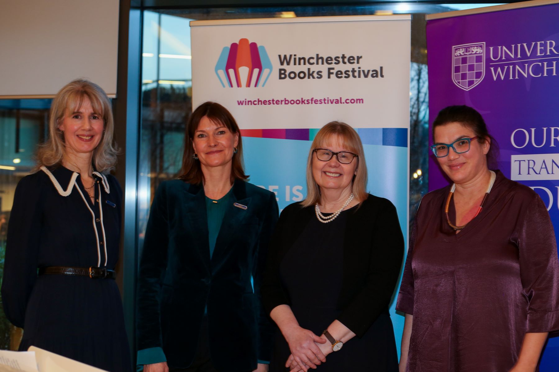 Three women in front of banner for Winchester Books Festival
