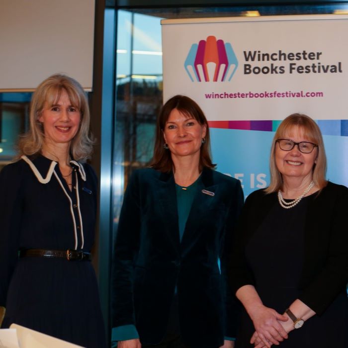 Three women in front of banner for Winchester Books Festival