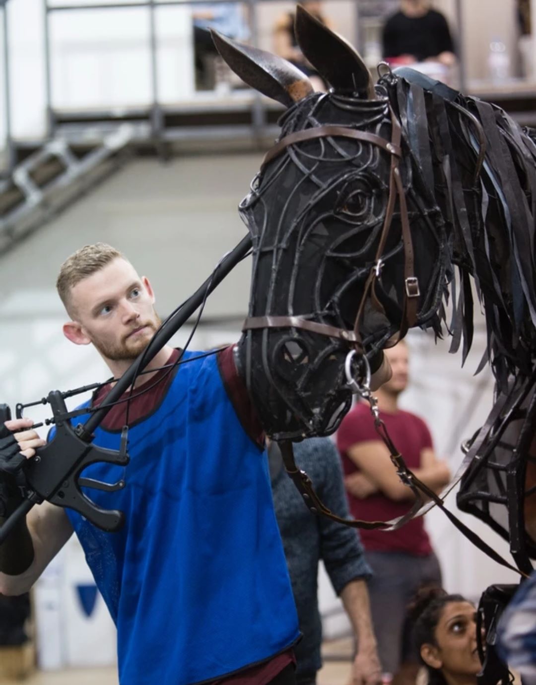 Ginger bearded man with life-size horse puppet