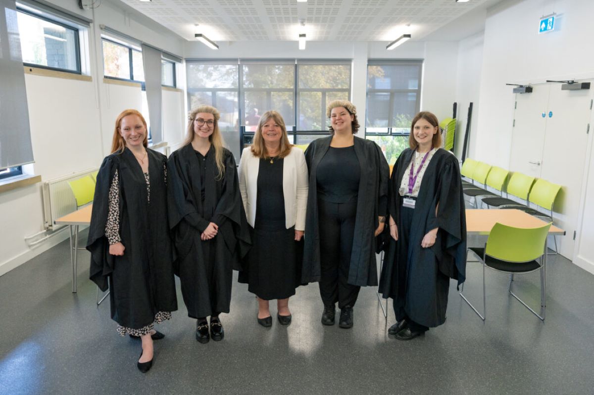 Line up of women dressed as courtroom lawyers