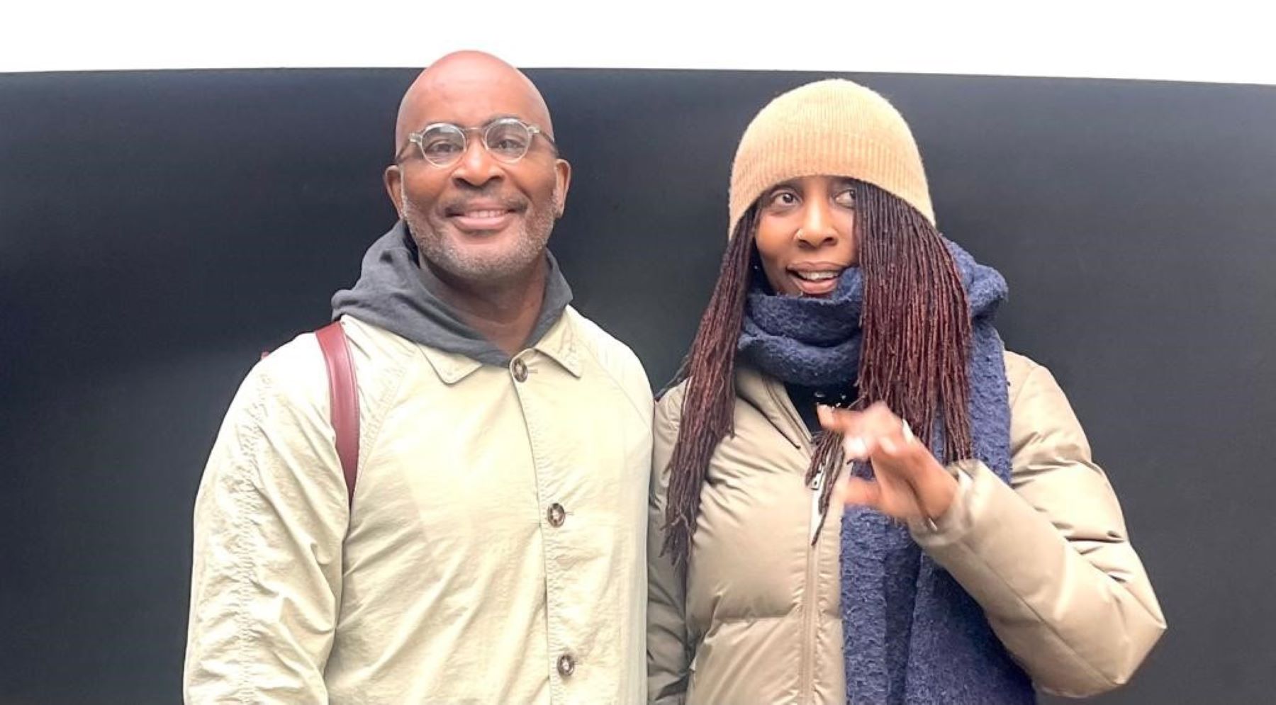 Man and woman standing close together wrapped up for cold weather