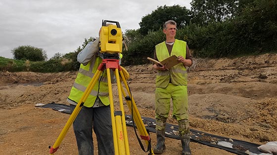 Professor Keith Wilkinson and colleague surveying the dig site