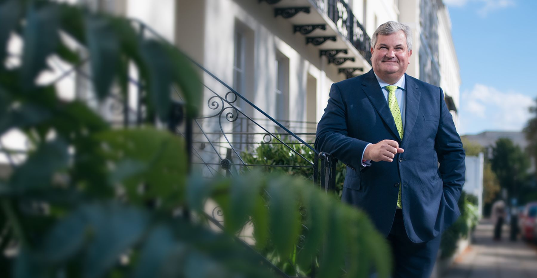 Man in suit standing in posh street