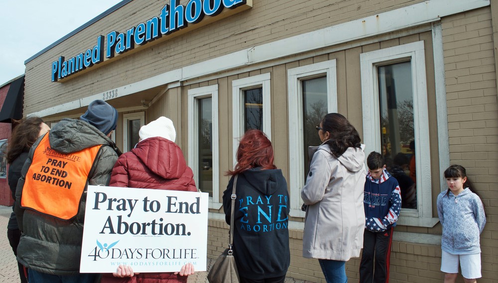 Protesters in prayer outside abortion clinic