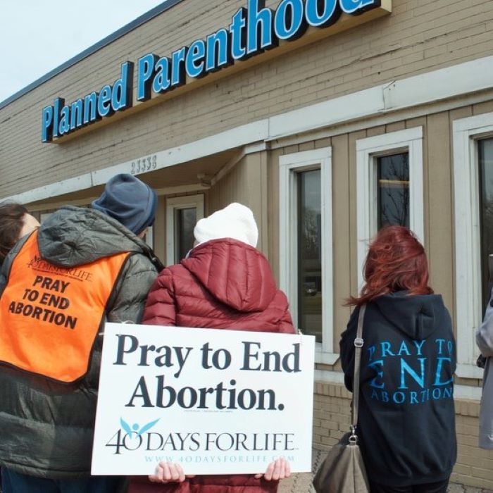 Protesters in prayer outside abortion clinic