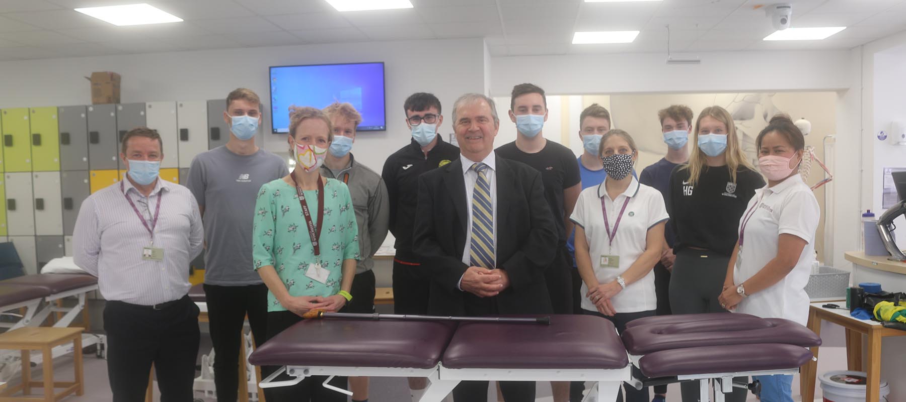 Sir Freddie standing in the centre of a group of Physiotherapy staff and students