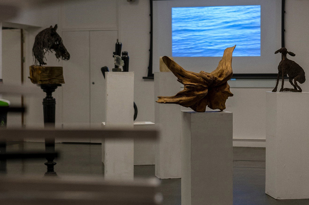 Interior of art gallery with sculptures on plinths