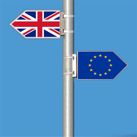 UK and EU Flags displayed as opposing directions on a signpost