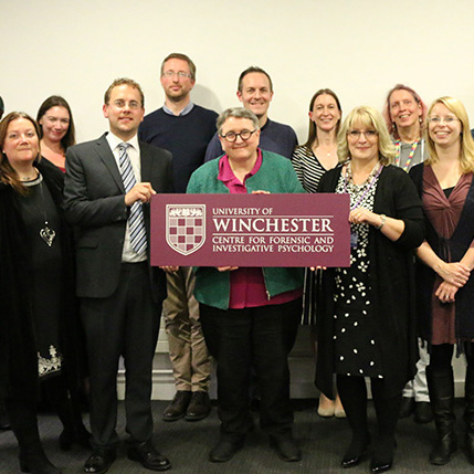 Centre for Forensic and Investigative Psychology launch team with university branded sign