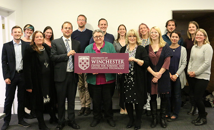 Centre for Forensic and Investigative Psychology launch team with university branded sign