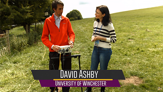 David Ashby talking to woman in field