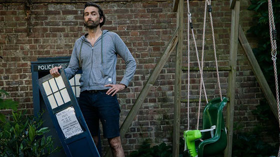 David Tennant, actor who formerly played Dr Who, standing by miniature broken tardis
