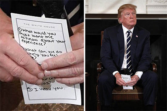 Close up of American President Donald Trump holding a partially obscured note, reading 