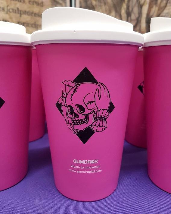Pink Gumdrop recycled, reusable coffee cup with cartoon image of hands holding skull