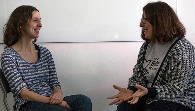 Woman listening to woman opposite, representing human library 'book'