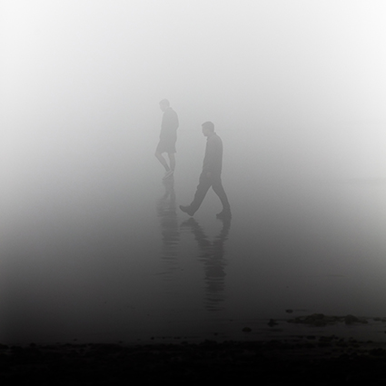 People walking in mist