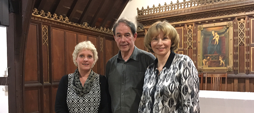 Sir Jonathon Porritt stood between two women, smiling