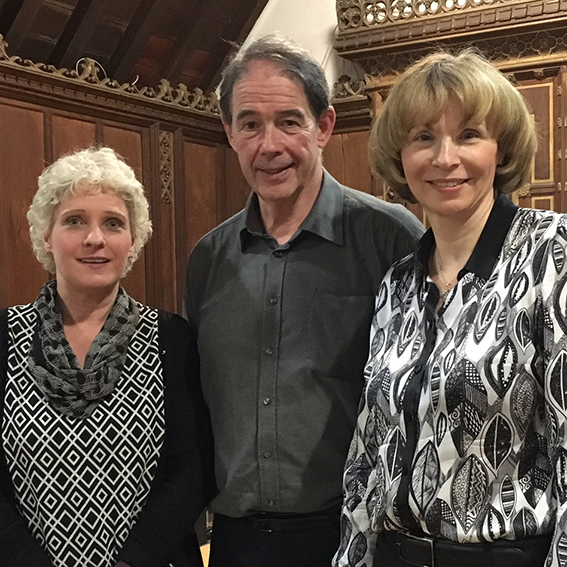 Sir Jonathon Porritt stood between two women, smiling