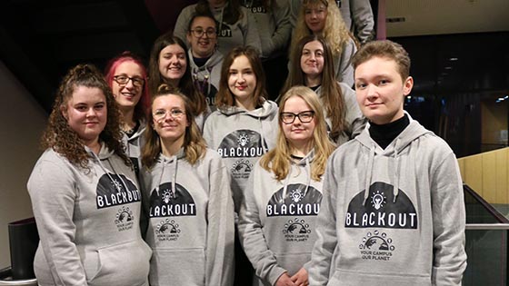 Students wearing balckout hoodies