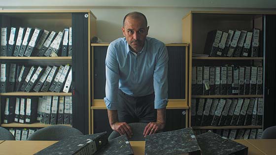 Dr Brian Thornton standing behind a desk