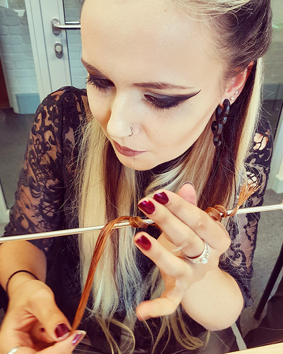 Victorian mourning hairwork techniques demonstrated by Courtney Lane, pictured wrapping hair around shaping rod