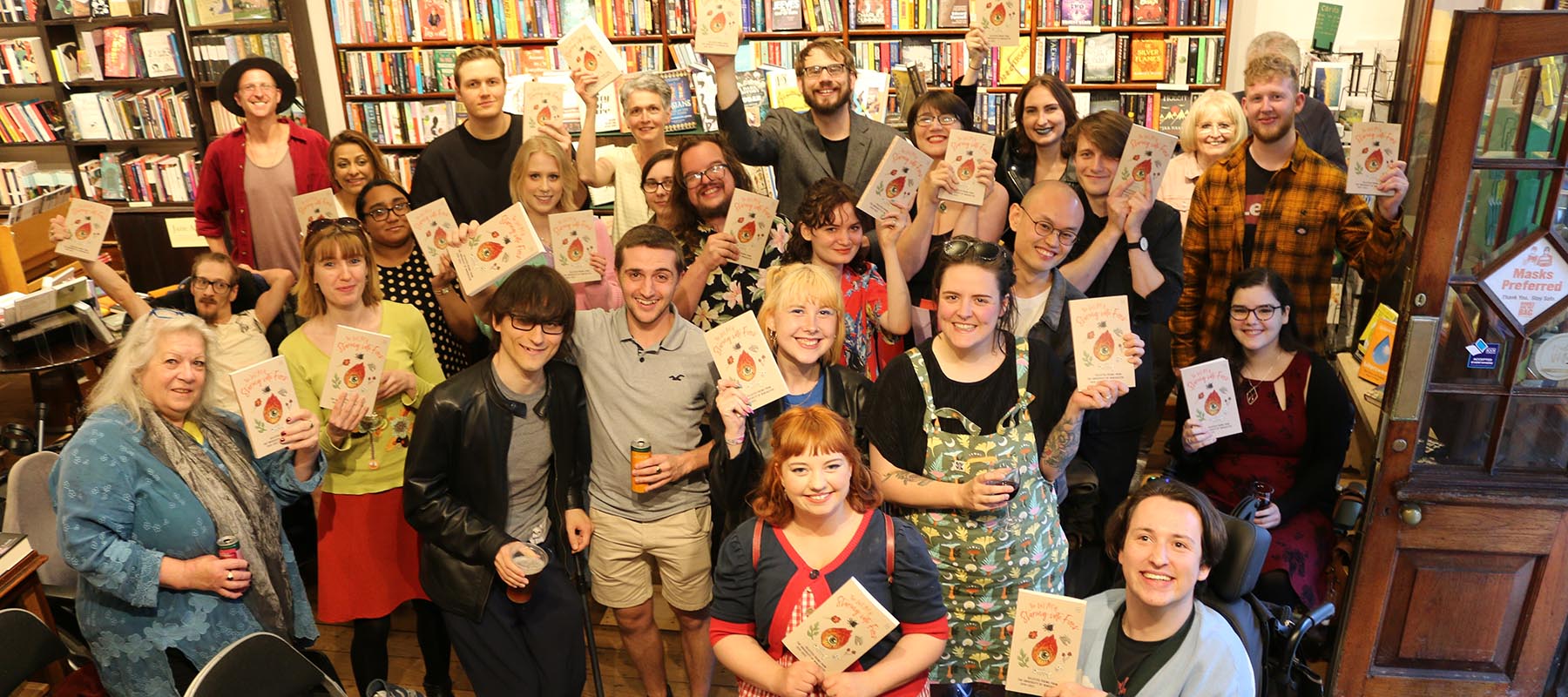 Group of students holding the poetry anthology at the launch event