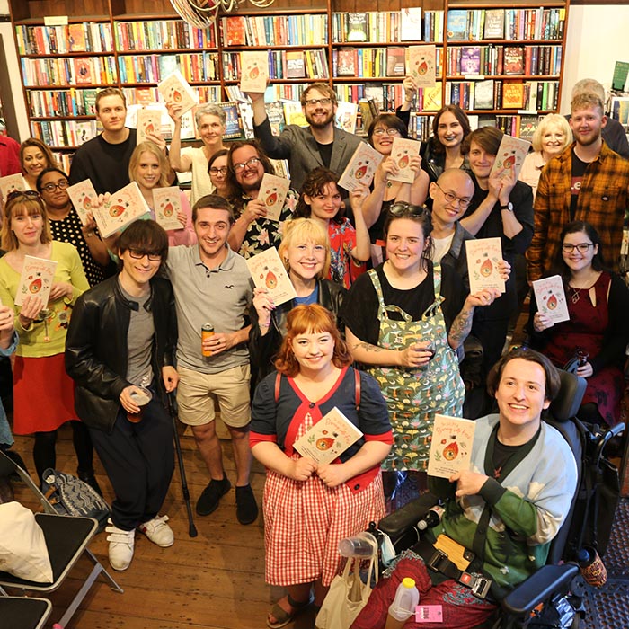 Group of students holding the poetry anthology at the launch event