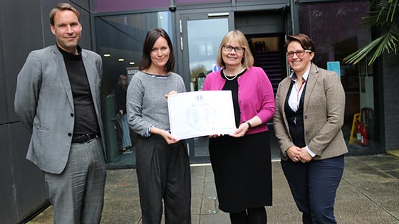 Professor Sarah Greer with the University of Sanctuary certificate