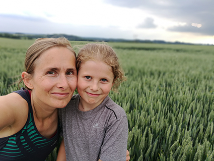 Olena Waskiewicz preparing for Winchester Half Marathon with daughter in field