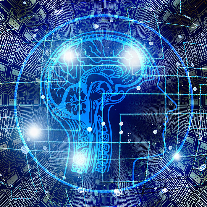 Science-fiction themed image of outline of a human head overlaid over a computer circuit style pattern