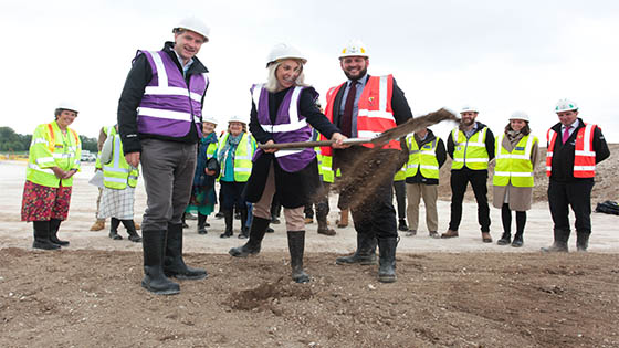 Joy Carter breaking ground with shovel at Barton Farm