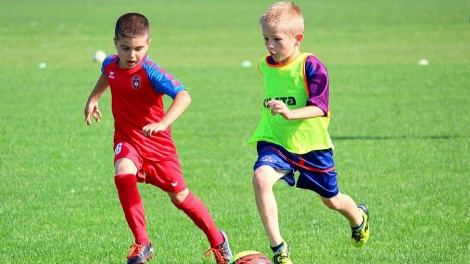 School boys playing football