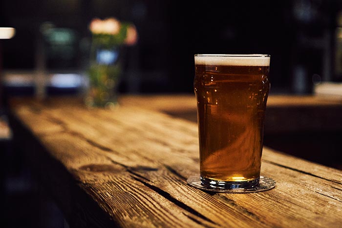 Beer sat on a bar countertop