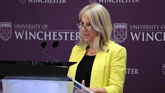 Joy Carter speaking at a lectern