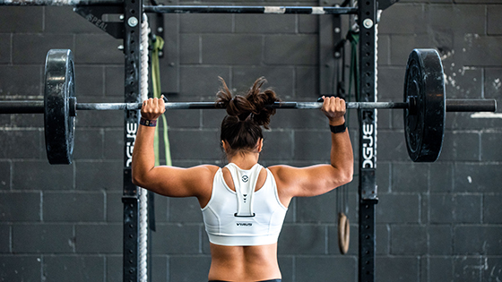 Women lifting barbell