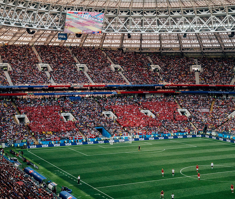 Wide shot of football stadium including audience and pitch