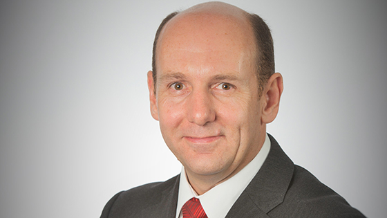 Martin Broad smiling in smart suit and tie