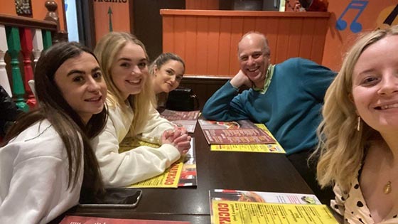 Four Law student and lecturer sitting around a table