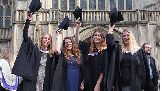 Graduates raise caps in celebration