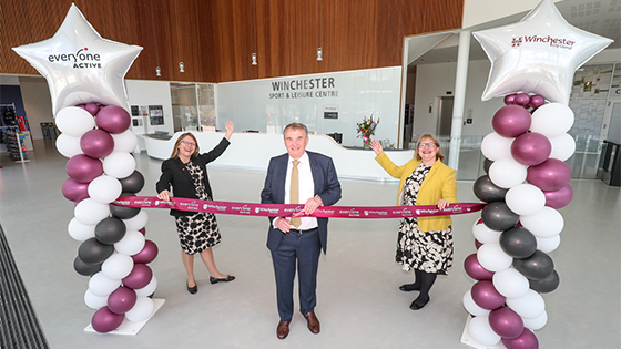 Man cutting red ribbon