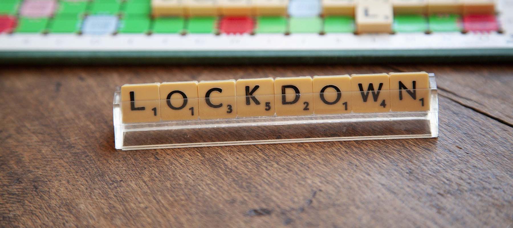 Strip of Scrabble letters that spell 'lockdown'