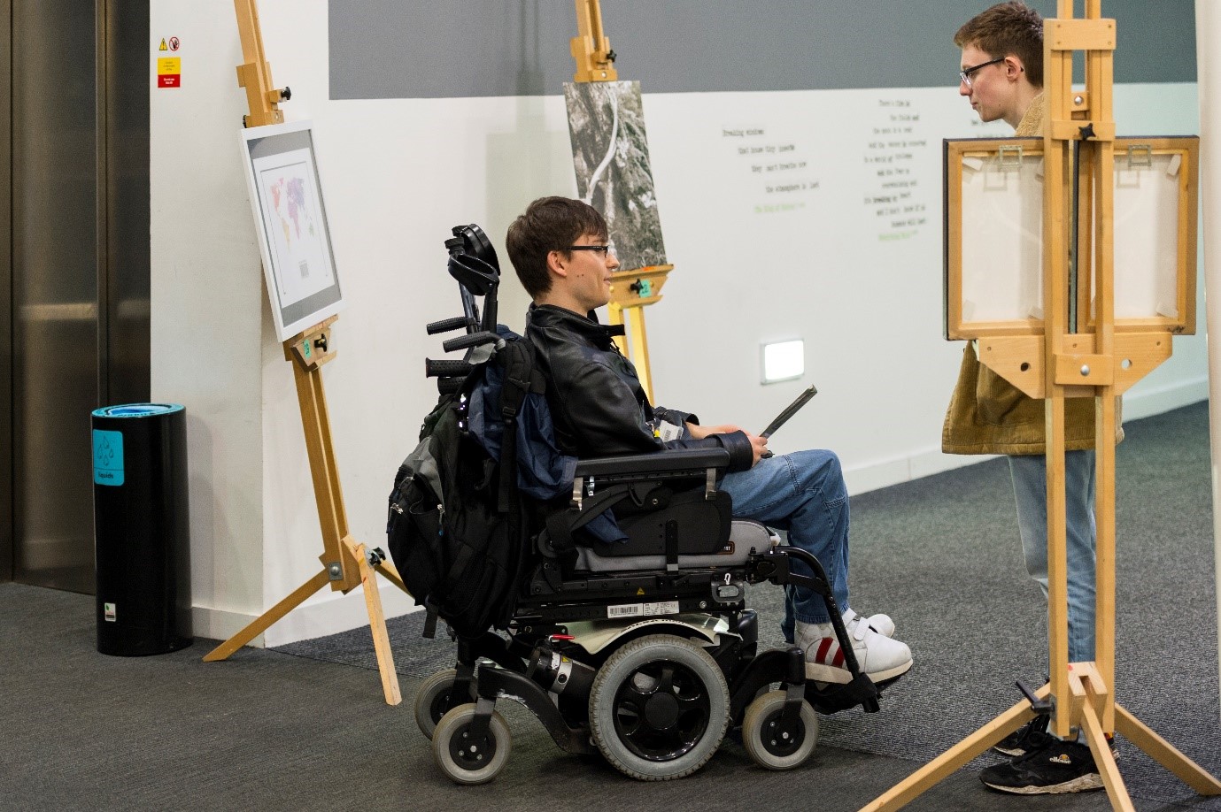 man in wheelchair at This changes everything exhibit