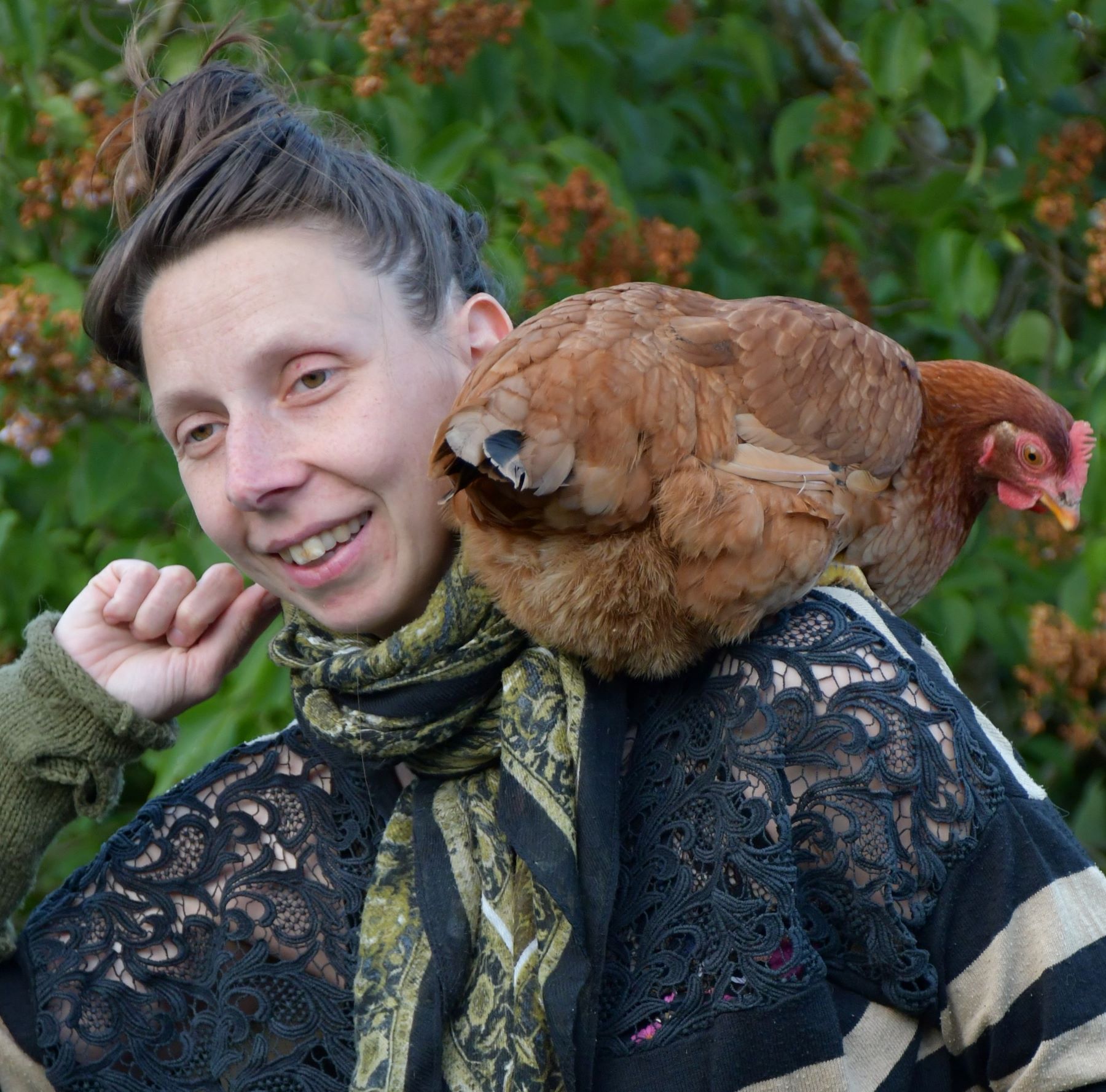 Woman with hen on her shoulder