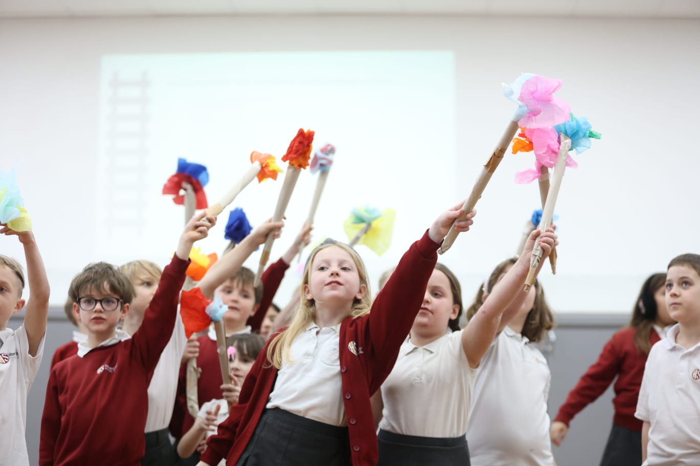 Children waving paper flowers