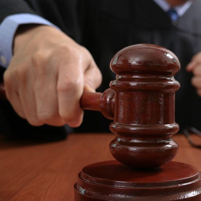 A mock trial in a court room with people in legal wigs and gowns